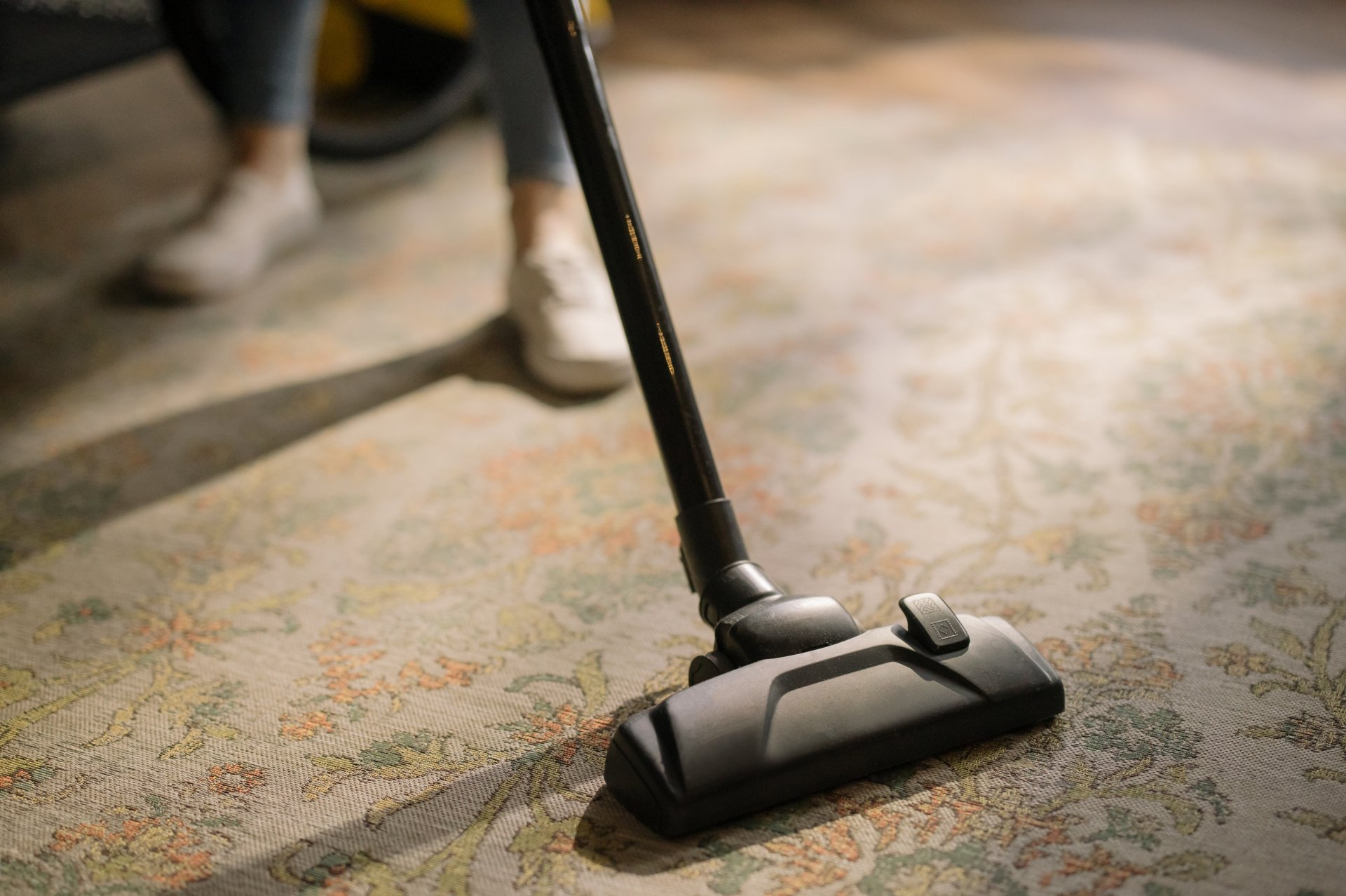 Vacuum cleaner cleaning a patterned carpet.